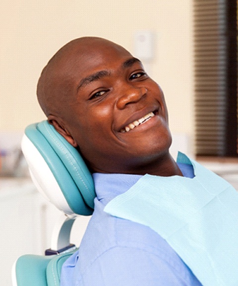 A man lying back in the dentist’s chair preparing to undergo periodontal therapy in Mayfield Heights